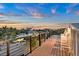 Rooftop deck features outdoor seating and a view of a city skyline with a colorful sunset at 119 Avenida Messina, Sarasota, FL 34242