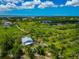 Captivating aerial view of a home with a metal roof surrounded by tropical vegetation, ponds and stunning scenery at 1230 Bayshore Dr, Terra Ceia, FL 34250