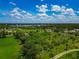 Aerial view of neighborhood with waterfront views, lush landscape, and clear blue skies at 1230 Bayshore Dr, Terra Ceia, FL 34250