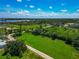Picturesque aerial shot showcasing a lush green landscape and trees, featuring a serene waterfront view and a clear blue sky at 1230 Bayshore Dr, Terra Ceia, FL 34250