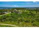 Aerial view of neighborhood featuring lush landscape and mature trees at 1230 Bayshore Dr, Terra Ceia, FL 34250