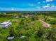 Beautiful aerial view showcasing lush surroundings with a house featuring multiple stories and scenic views at 1230 Bayshore Dr, Terra Ceia, FL 34250