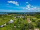 Beautiful aerial view of a multi-story home near the water, offering peaceful living and stunning views at 1230 Bayshore Dr, Terra Ceia, FL 34250