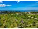 Panoramic aerial view of land with trees and homes, showcasing a serene, lush environment with a clear blue sky backdrop at 1230 Bayshore Dr, Terra Ceia, FL 34250