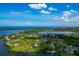 Breathtaking aerial view featuring waterfront properties, interconnected waterways, and lush greenery under a vibrant sky at 1230 Bayshore Dr, Terra Ceia, FL 34250
