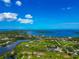 Scenic aerial view of waterfront homes surrounded by lush greenery, offering stunning coastal views and serene living at 1230 Bayshore Dr, Terra Ceia, FL 34250