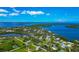 Scenic aerial perspective of charming waterfront community with picturesque landscaping at 1230 Bayshore Dr, Terra Ceia, FL 34250
