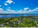 Expansive aerial view showcasing waterfront property with lush greenery and stunning water views at 1230 Bayshore Dr, Terra Ceia, FL 34250