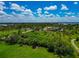 Overhead view featuring a sprawling green landscape dotted with houses surrounded by lush trees in a scenic neighborhood at 1230 Bayshore Dr, Terra Ceia, FL 34250