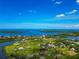 Expansive aerial view capturing waterfront properties, tranquil waterways, and a bridge in a serene, green environment at 1230 Bayshore Dr, Terra Ceia, FL 34250