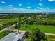 Aerial perspective capturing green spaces and roads in a quiet neighborhood near the water at 1230 Bayshore Dr, Terra Ceia, FL 34250