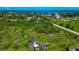 Expansive aerial view of lush property with mature trees, highlighting its natural beauty and potential at 1230 Bayshore Dr, Terra Ceia, FL 34250