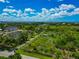 Aerial view capturing waterfront properties with ponds and lush landscape, complemented by scenic water views at 1230 Bayshore Dr, Terra Ceia, FL 34250