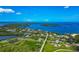 Picturesque aerial view of waterfront homes nestled along the bay, offering stunning views and coastal living at 1230 Bayshore Dr, Terra Ceia, FL 34250