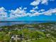 Stunning aerial view of a waterfront property with lush greenery and picturesque water views under a partly cloudy blue sky at 1230 Bayshore Dr, Terra Ceia, FL 34250