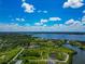 Expansive aerial view featuring waterfront properties, tranquil waterways, and a lush green environment under a vibrant sky at 1230 Bayshore Dr, Terra Ceia, FL 34250