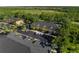 Aerial view of townhome community with well-maintained landscaping, parking, and surrounding greenery at 13084 Tigers Eye Dr, Venice, FL 34292