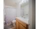 Bright bathroom featuring a shower-tub combo with modern white vanity and framed mirror at 13084 Tigers Eye Dr, Venice, FL 34292