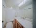 Clean bathroom featuring white vanity, framed mirror, shower-tub combo, and neutral color palette at 13084 Tigers Eye Dr, Venice, FL 34292