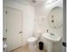 Cozy bathroom with a pedestal sink, toilet, and a vanity mirror at 13084 Tigers Eye Dr, Venice, FL 34292