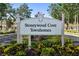 Community entrance sign reading 'Stoneywood Cove Townhomes' with manicured landscaping at 13084 Tigers Eye Dr, Venice, FL 34292