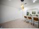 Dining area featuring tiled floors, pendant lighting, and a view to an arched kitchen at 13084 Tigers Eye Dr, Venice, FL 34292