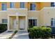 Up close view of the townhome's entrance, showing the individual unit numbers and well-kept landscaping at 13084 Tigers Eye Dr, Venice, FL 34292