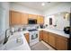 Bright kitchen features ample counter space, wood cabinetry, and modern appliances at 13084 Tigers Eye Dr, Venice, FL 34292