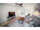 Open living room with a large television, comfortable seating, and modern decor at 13084 Tigers Eye Dr, Venice, FL 34292