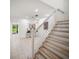 Open living space featuring tiled floors, stairs, and view to an arched opening at 13084 Tigers Eye Dr, Venice, FL 34292