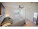 Inviting bedroom features a comfortable bed, a ceiling fan, and natural light at 13084 Tigers Eye Dr, Venice, FL 34292