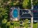 Overhead view of a sparkling pool surrounded by lush landscaping and lounge chairs at 13084 Tigers Eye Dr, Venice, FL 34292