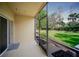 View of the screened lanai overlooking the green backyard and mature trees at 13084 Tigers Eye Dr, Venice, FL 34292