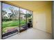 Screened patio overlooking the backyard featuring white door and natural light at 13084 Tigers Eye Dr, Venice, FL 34292