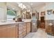 Bathroom with double vanity, shower, tile floors, and wallpaper at 1415 Millbrook Cir, Bradenton, FL 34212
