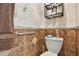 Bathroom featuring earth-toned tile, grab bar, toilet paper shelf, and towel at 1415 Millbrook Cir, Bradenton, FL 34212