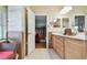 Bathroom featuring a vanity with double sinks and an open doorway to the adjacent room at 1415 Millbrook Cir, Bradenton, FL 34212