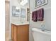 Bright bathroom with wooden vanity, double mirrors, modern lighting, and fresh towels at 1415 Millbrook Cir, Bradenton, FL 34212
