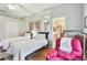 Bedroom with two twin beds, hardwood floors, reading chair, and ensuite bath access at 1415 Millbrook Cir, Bradenton, FL 34212