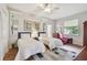 Bright bedroom with two twin beds, hardwood floors, large windows, and a cozy reading chair at 1415 Millbrook Cir, Bradenton, FL 34212