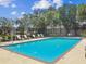 Inviting community pool with ample seating, surrounded by lush greenery, perfect for relaxation and recreation at 1415 Millbrook Cir, Bradenton, FL 34212