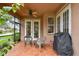 Inviting covered patio with tiled floor, ceiling fan, and convenient access to the interior at 1415 Millbrook Cir, Bradenton, FL 34212