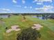 Picturesque golf course with manicured greens, sand traps, and mature trees from an aerial perspective at 1415 Millbrook Cir, Bradenton, FL 34212