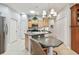 Bright eat-in kitchen featuring stainless steel appliances, breakfast bar, and tile flooring at 1415 Millbrook Cir, Bradenton, FL 34212