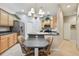 Charming eat-in kitchen with stainless steel appliances, breakfast bar, and chandelier lighting at 1415 Millbrook Cir, Bradenton, FL 34212