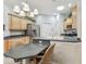 Charming eat-in kitchen with stainless steel appliances, breakfast bar, and chandelier lighting at 1415 Millbrook Cir, Bradenton, FL 34212