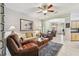 Spacious living room with plush seating, a ceiling fan, and an open layout leading to other areas of the home at 1415 Millbrook Cir, Bradenton, FL 34212