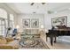 Bright living room with neutral tones, large windows, and a grand piano at 1415 Millbrook Cir, Bradenton, FL 34212