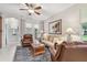Inviting living room features cozy seating, a ceiling fan, an area rug, and bright, natural light at 1415 Millbrook Cir, Bradenton, FL 34212