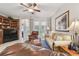 Comfortable living room with ceiling fan, neutral tones, entertainment center, and access to the outdoors at 1415 Millbrook Cir, Bradenton, FL 34212